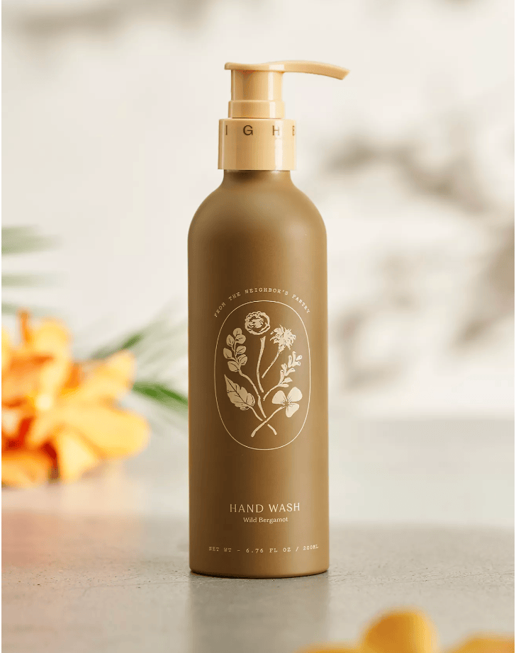 Brown hand wash bottle with floral design on a blurred background