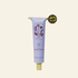 Hand balm tube with floral design and gold cap on a white background