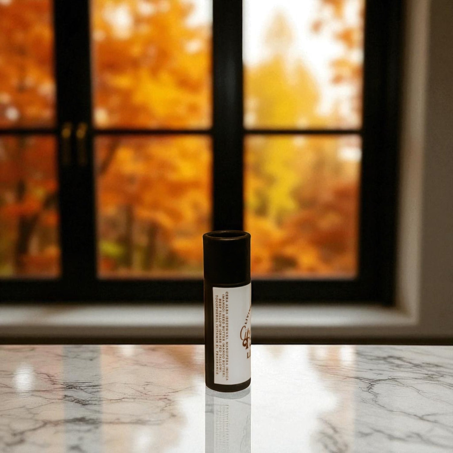 Product on a marble surface with a window in the background showing autumn foliage.