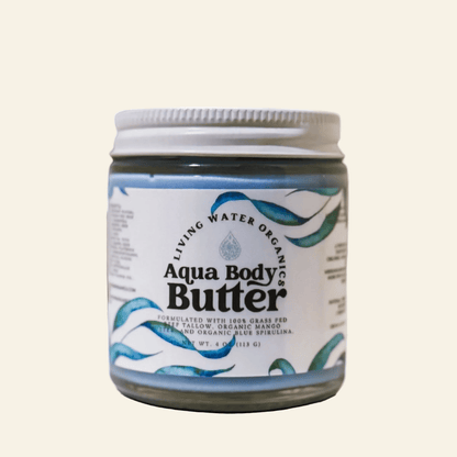 Jar of Aqua Body Butter with a white lid on a light beige background