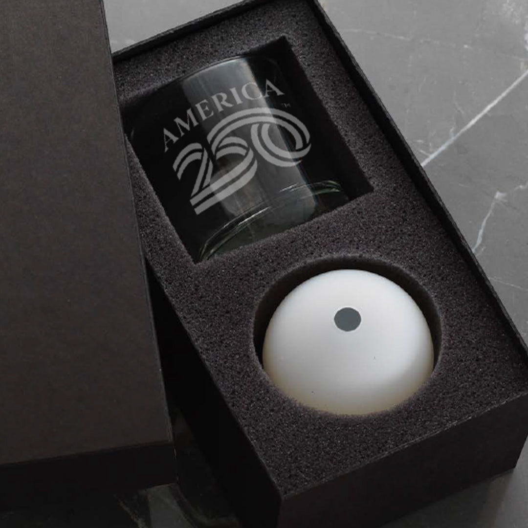 Gift set with a glass and a white ball in a black box