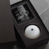 Gift set with a glass and a white ball in a black box