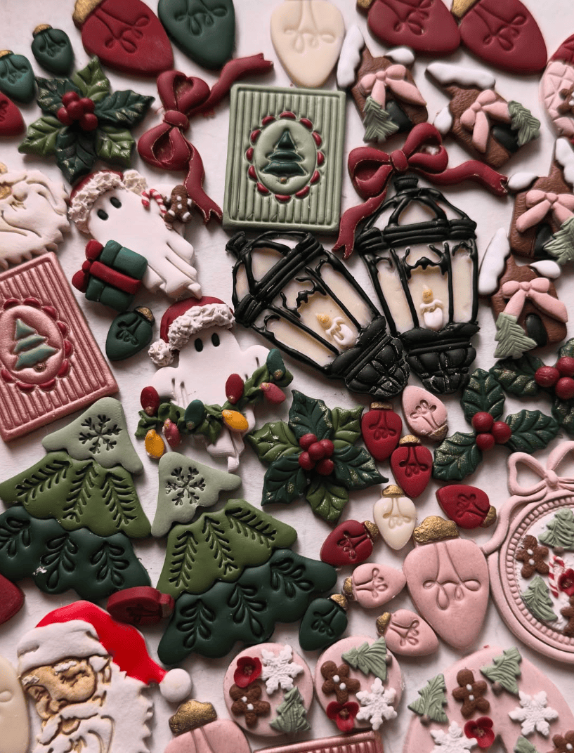 Assorted Christmas-themed earrings with decorative icing on a white background