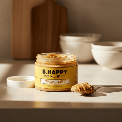 Jar of B.Happy peanut butter snack mix with a yellow label on a white background