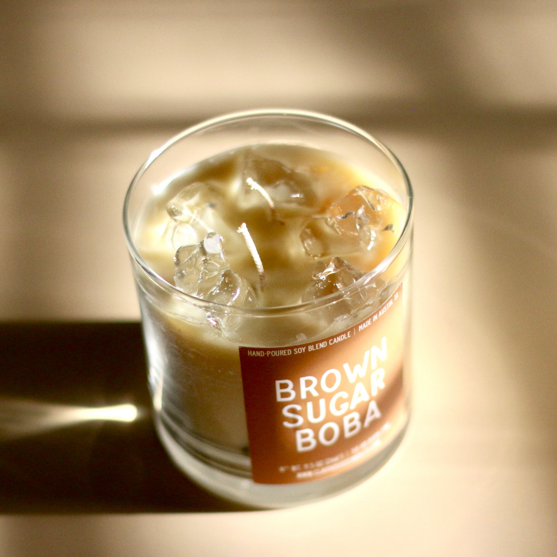Glass of iced beverage with a label on a wooden surface