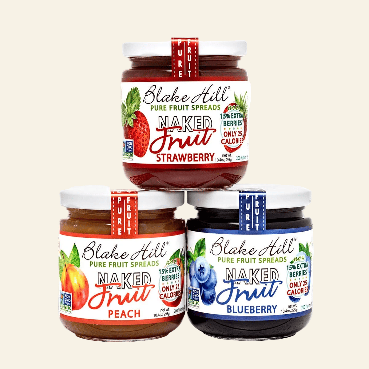Three jars of Blake Hill Naked Fruit Spreads in strawberry, peach, and blueberry flavors on a white background.