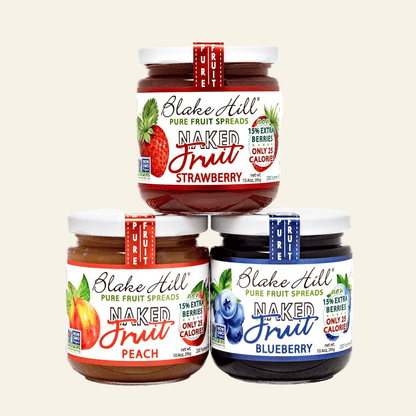 Three jars of Blake Hill Naked Fruit Spreads in strawberry, peach, and blueberry flavors on a white background.