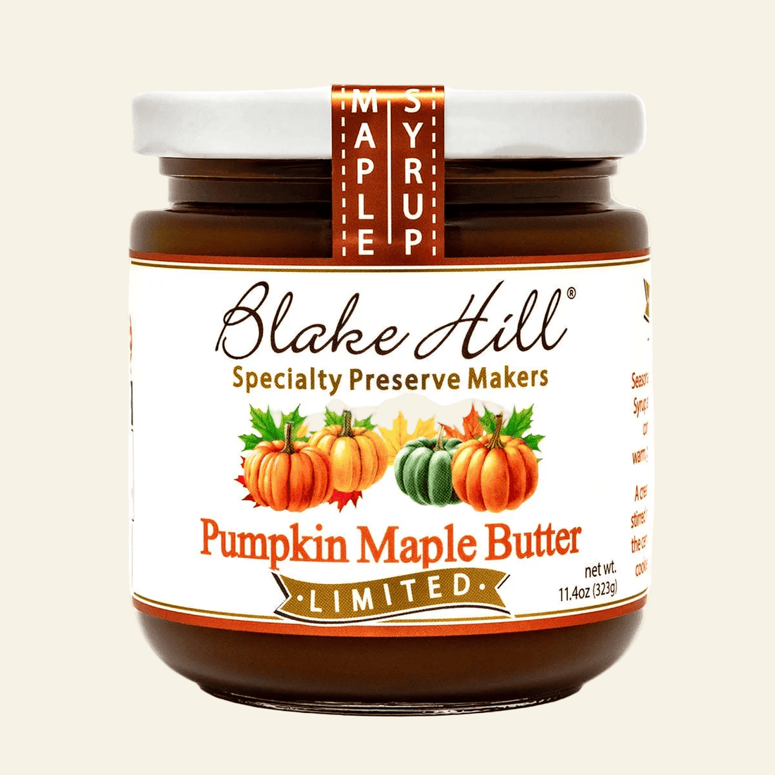 Jar of Blake Hill Pumpkin Maple Butter with a label featuring pumpkins and maple syrup text.