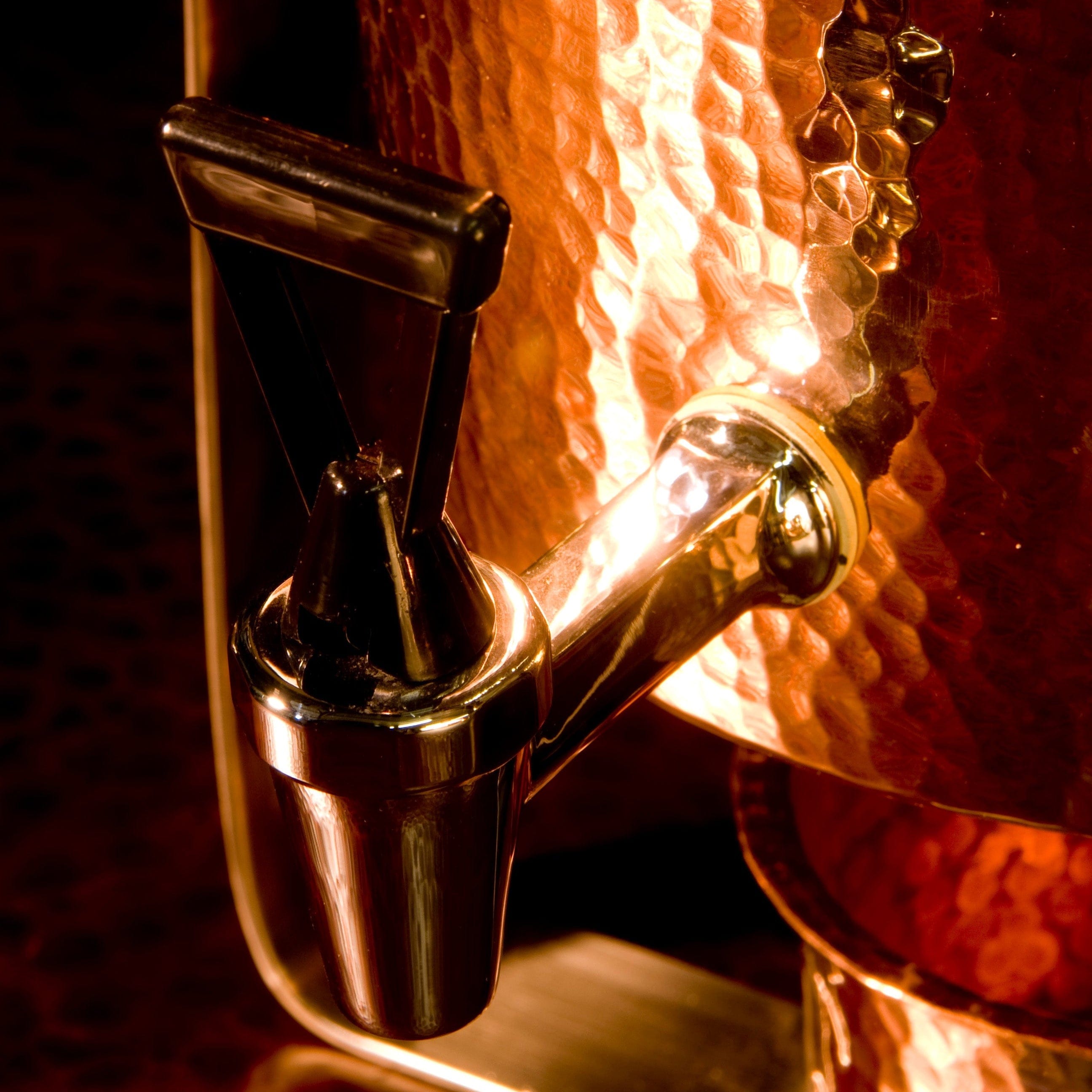 Close-up of a wine bottle stopper with a copper finish.