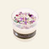 Candle with colorful crystals and a label on a white background