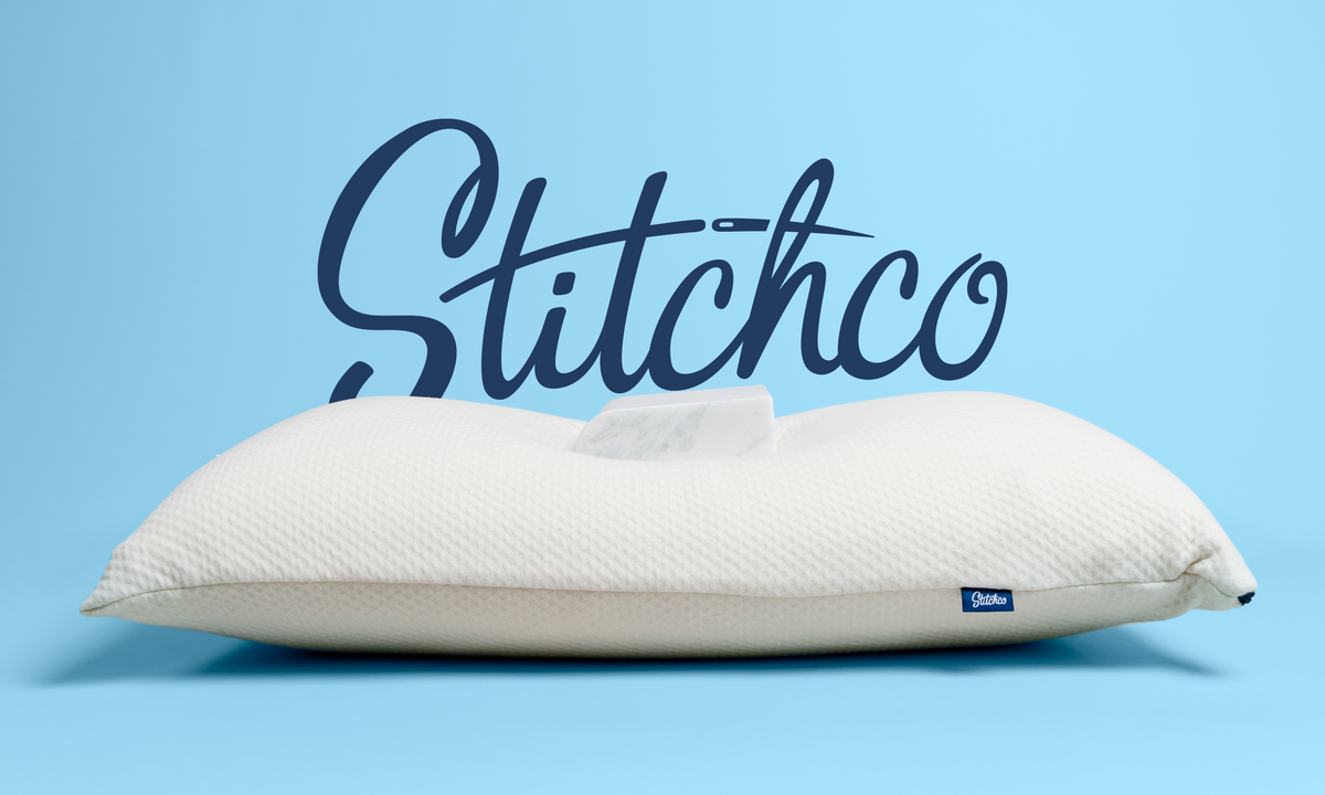 White pillow with Stitchco branding on a blue background