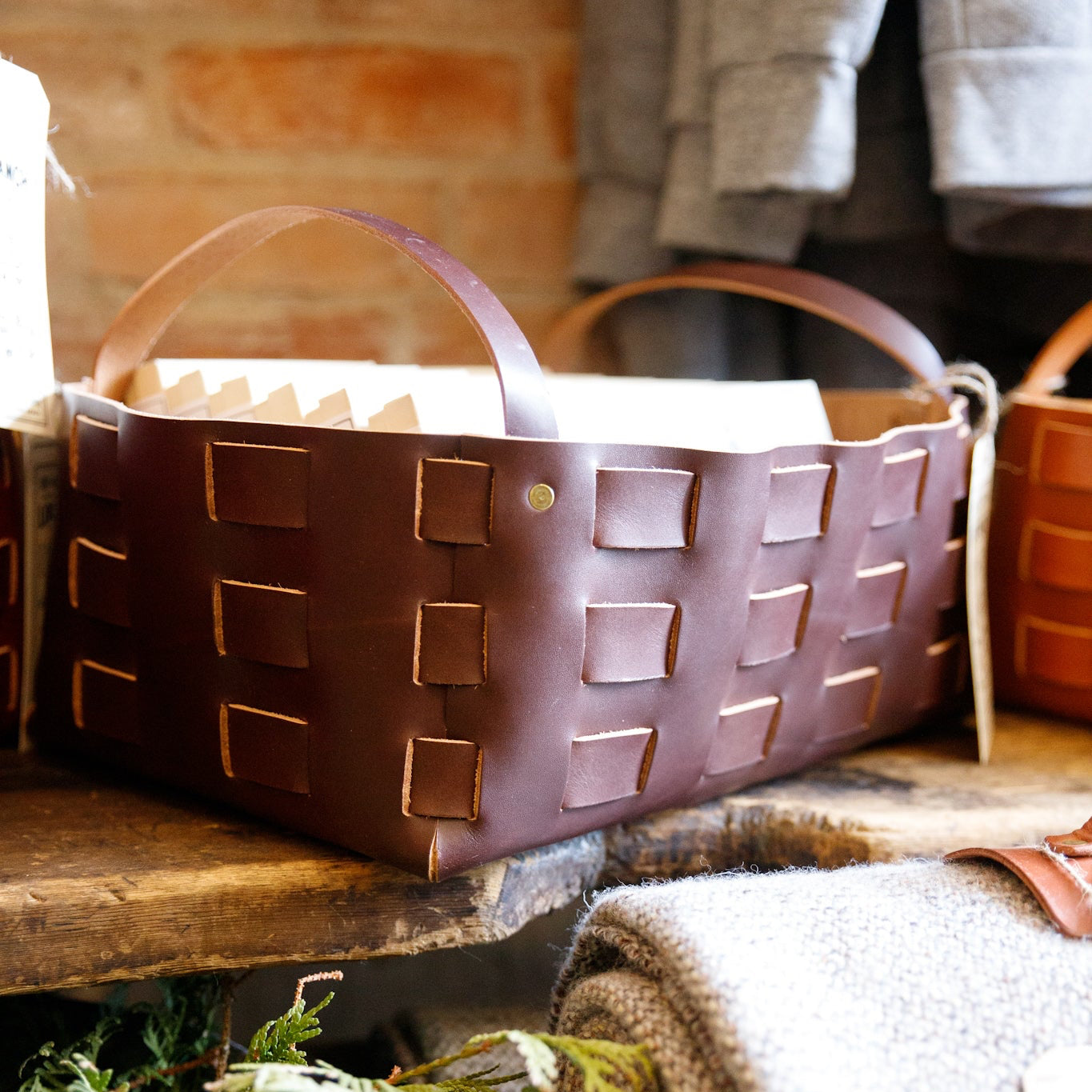Brown woven basket with a handle on a wooden surface