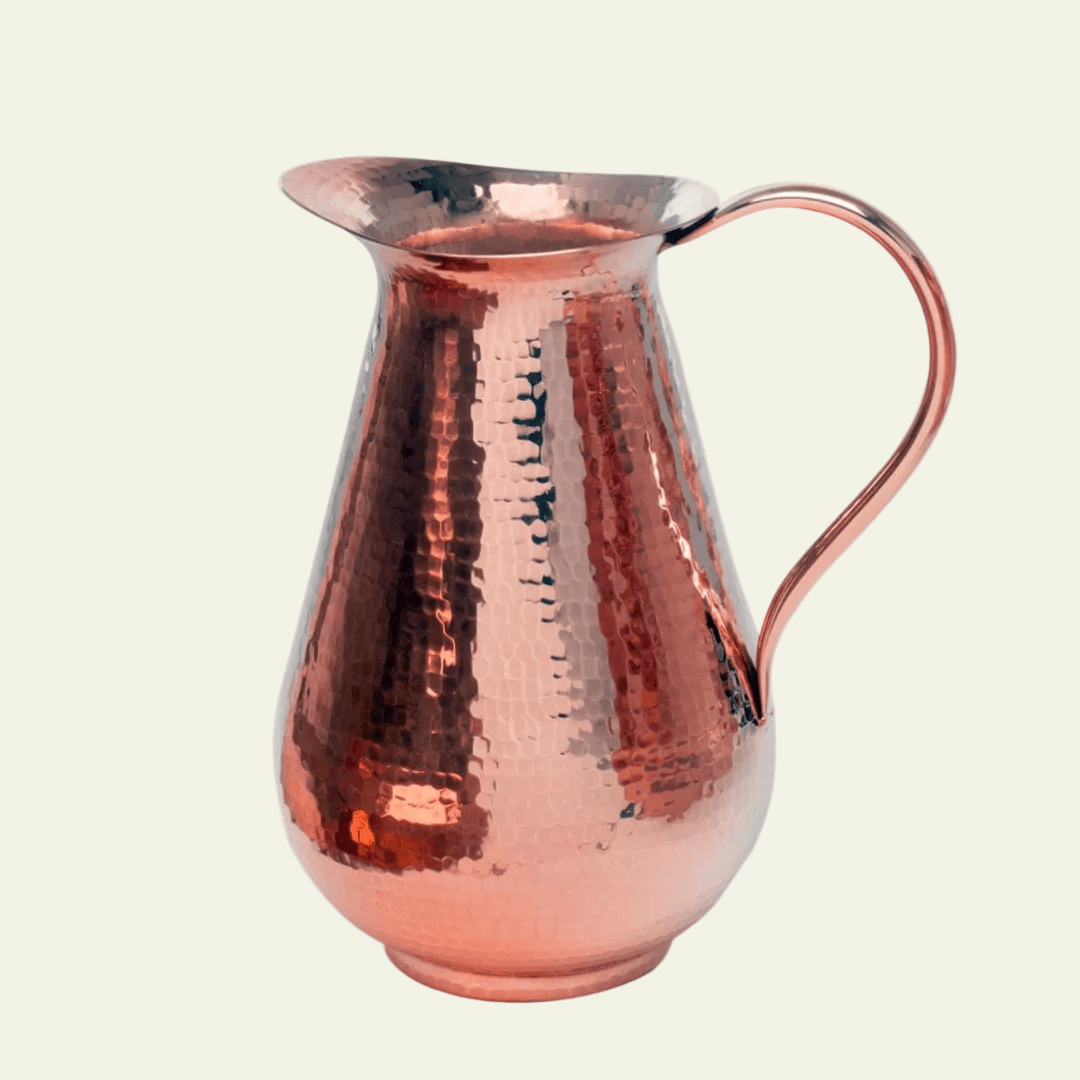 Copper pitcher on a white background