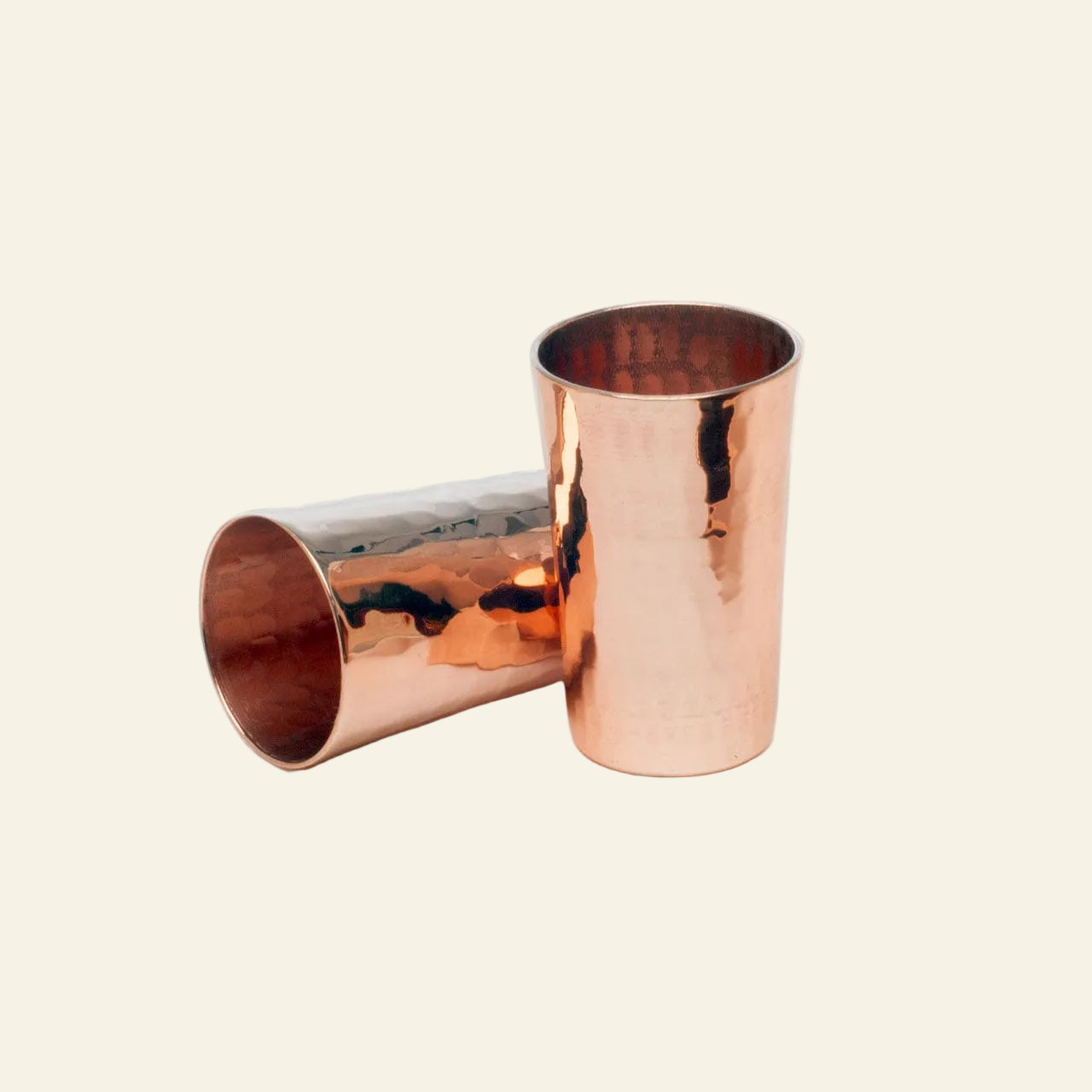 Two copper tumblers on a white background