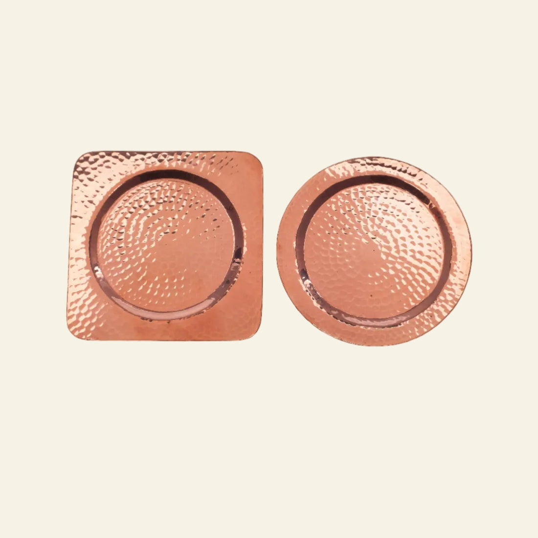 Two copper coasters, one square and one round, on a white background