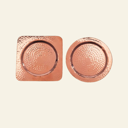 Two copper coasters, one square and one round, on a white background