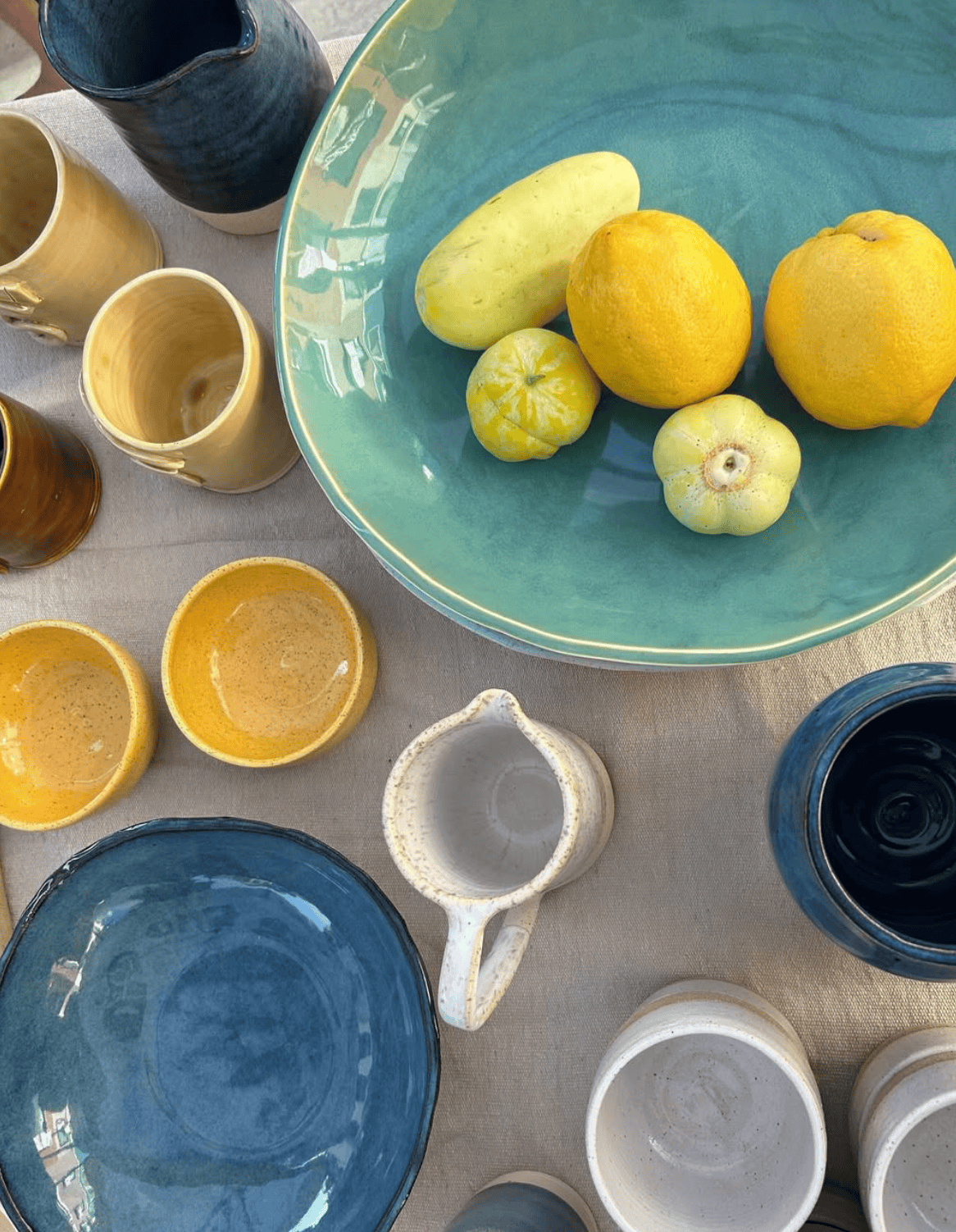 Ceramic bowls and lemons on a textured surface