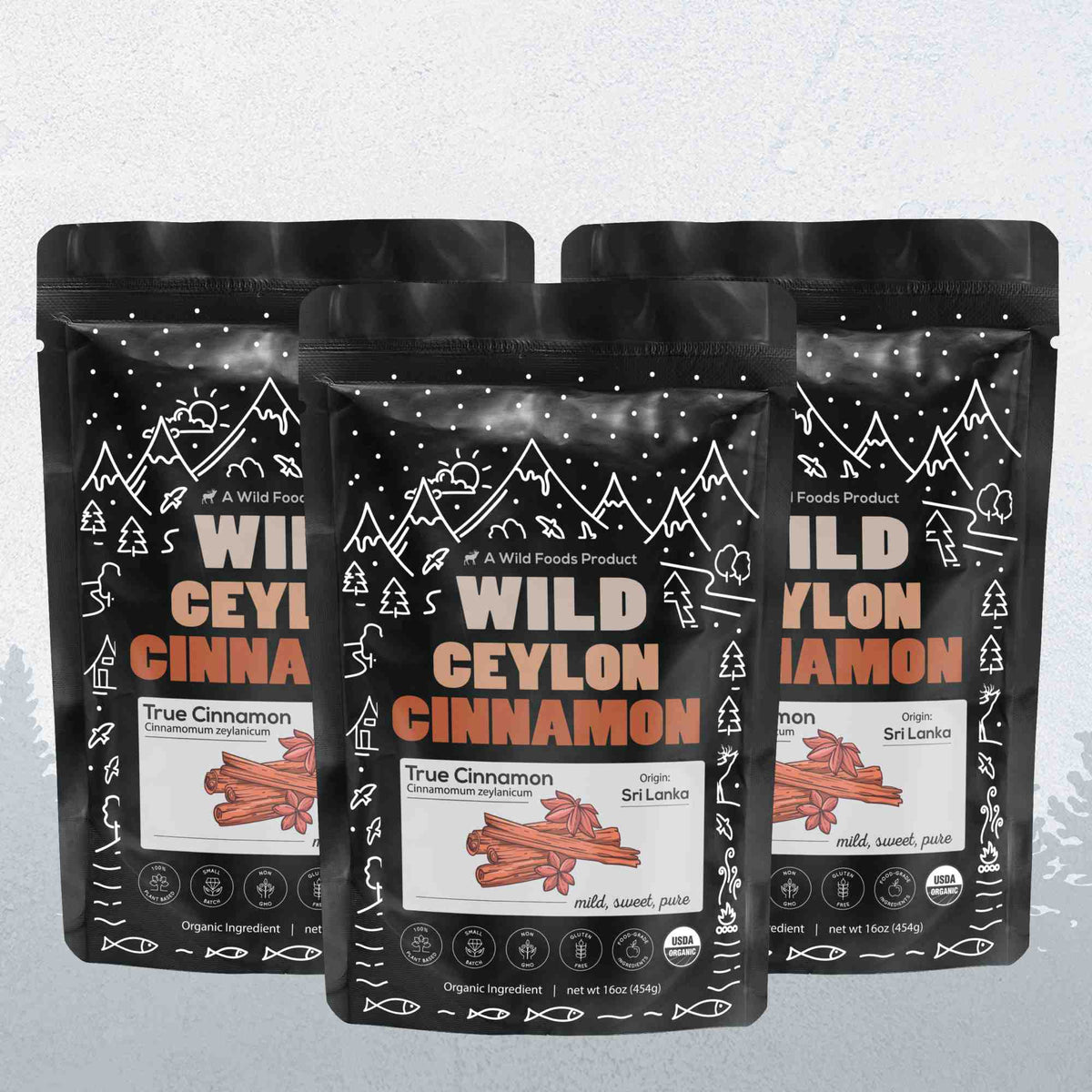 Three packages of Wild Ceylon Cinnamon with black and white design on a light gray background