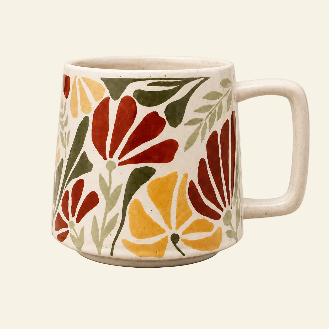 A ceramic mug with a retro floral pattern in red, yellow, and green on a cream-colored background, set against a solid cream backdrop.