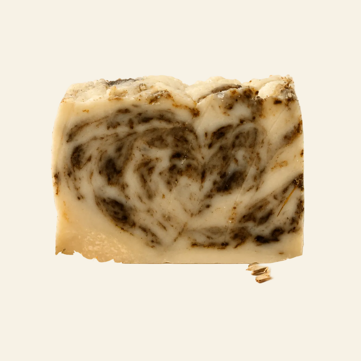 A bar of marbled facial soap labeled &
