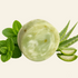 A round pale green soap bar labeled Aloe & Peppermint Soap Bar, shown with mint leaves, aloe vera leaves, and sliced aloe vera on a light cream background. Text below highlights botanical soap bar, gentle cleansing, and aloe vera + peppermint benefits.