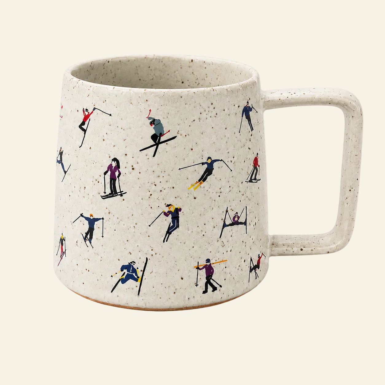 A speckled off-white ceramic mug with a handle, decorated with a repeating pattern of small skiers and snowboarders in various colorful outfits, set against a solid cream background.