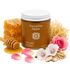 Jar of honeybee hippie honey with honeycomb, flowers, and a honey dipper on a white background
