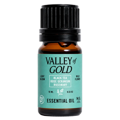 Valley of Gold essential oil bottle with black cap on a white background