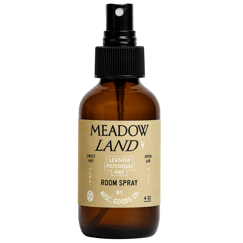 Brown glass bottle with black spray nozzle and 'Meadow Land' label on a white background