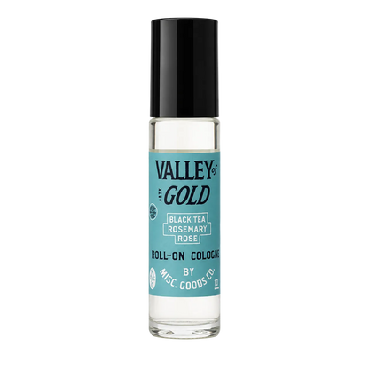 Roll-on cologne bottle with black cap and blue label on a white background