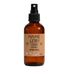 Brown glass room spray bottle with a cardboard label on a white background