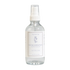 Clear bottle with white cap and label on a light beige background