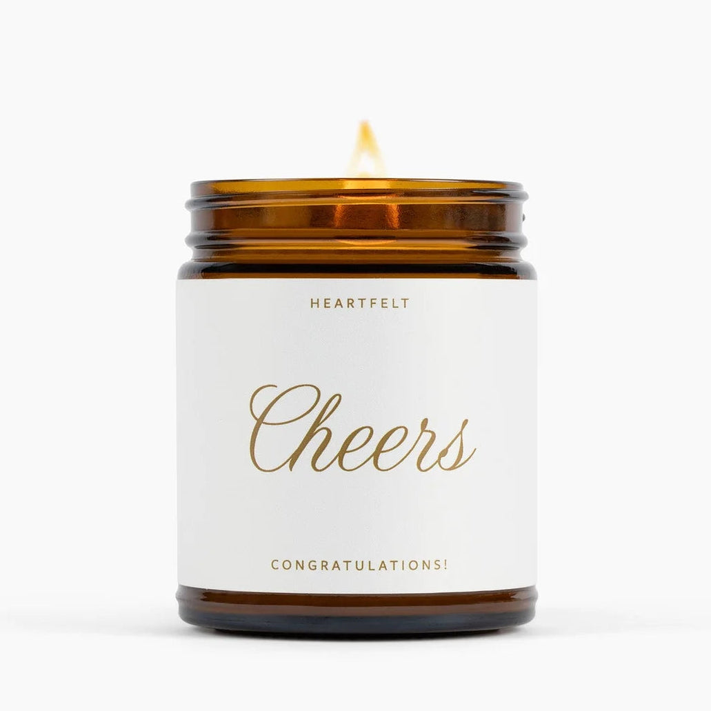 Candle with a white label reading &