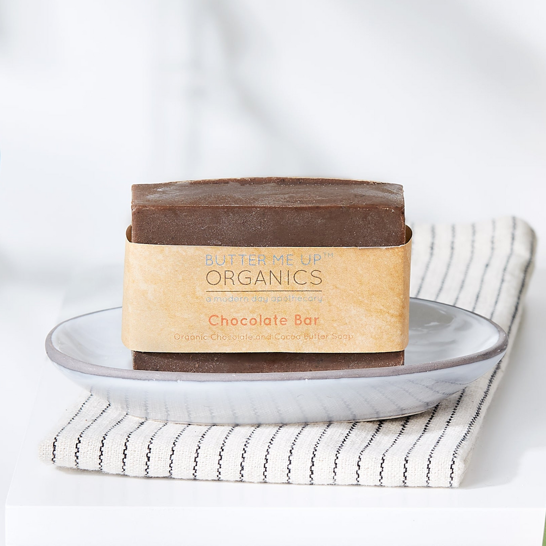 A chocolate bar wrapped in a kraft paper sleeve labeled &