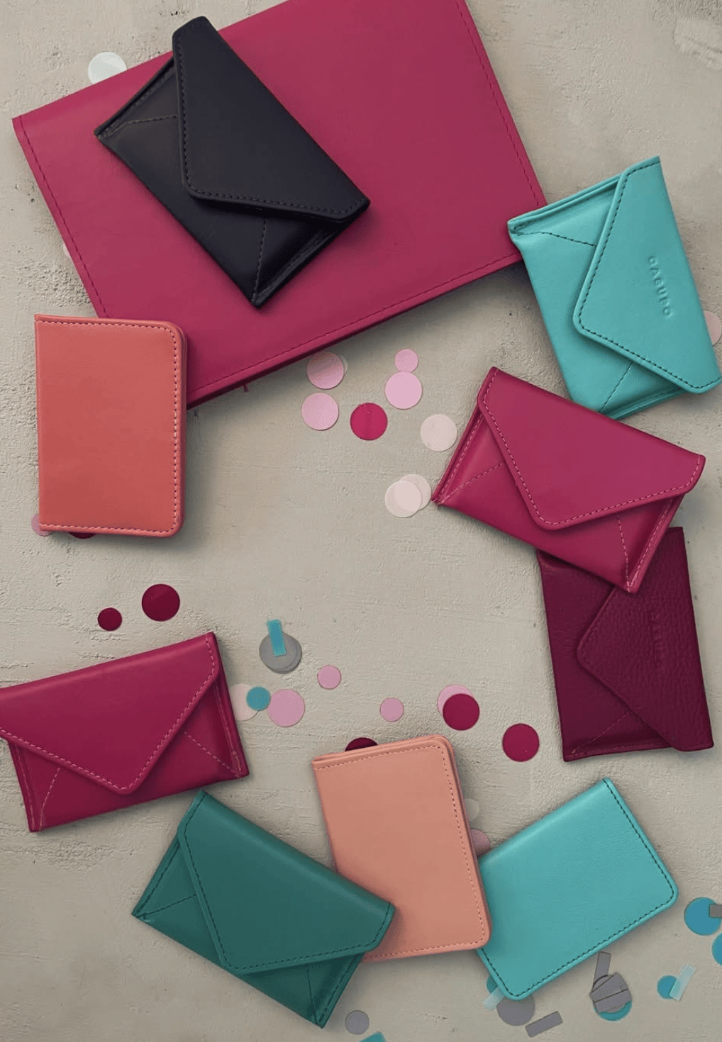 Collection of colorful leather wallets on a light background