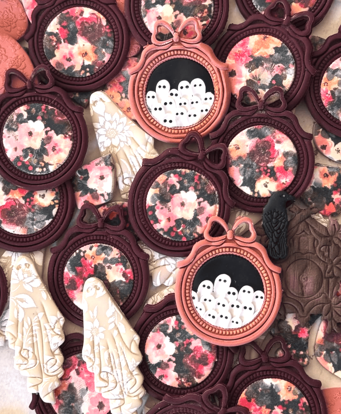 Collection of earrings with floral patterns and ghost designs.