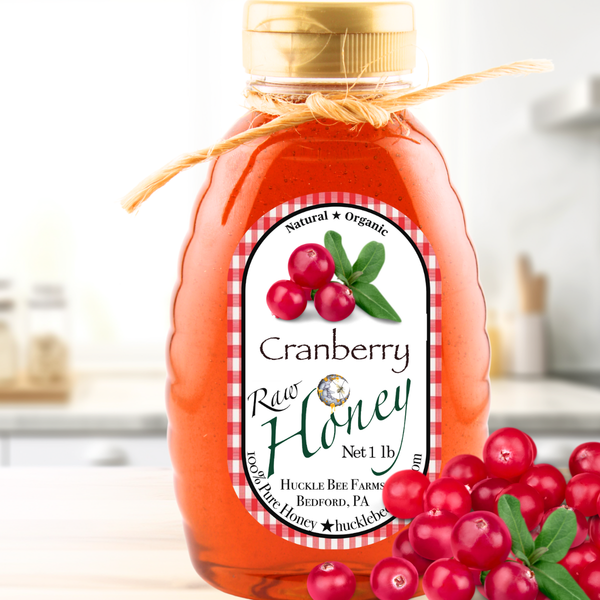 Bottle of cranberry raw honey with a label on a white background