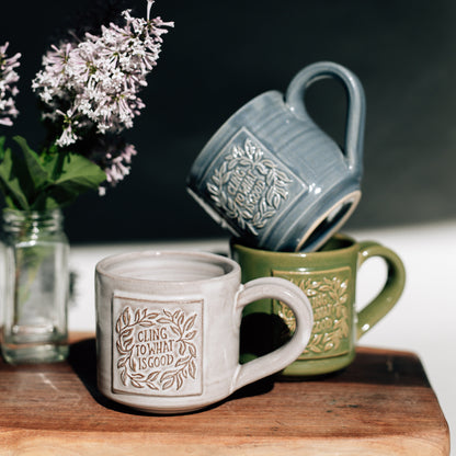 Three mugs on a wooden surface with a dark background