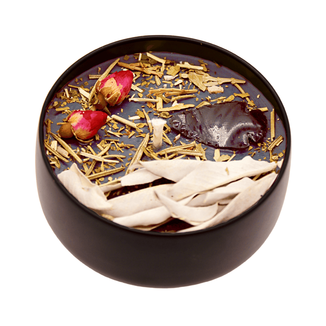 Black container with dried herbs and flowers on a white background