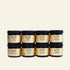 Set of six jars of San Pedrito honey on a white background