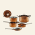 Set of copper cookware including pots and pans on a beige background