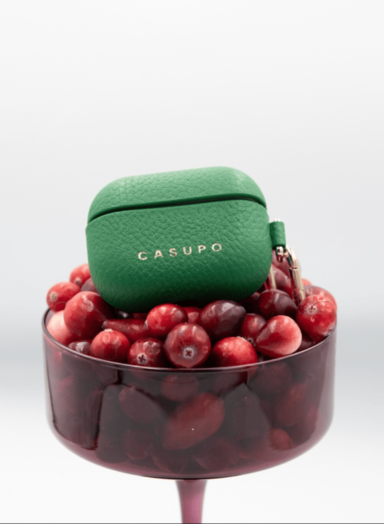 Green Casupo case on a glass with red berries
