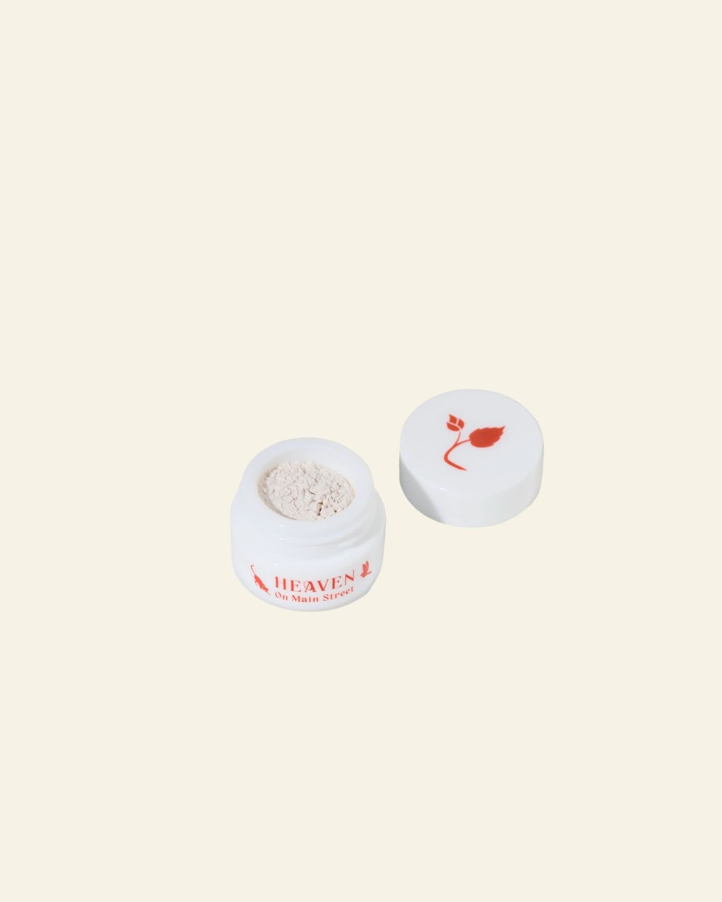 Cosmetic jar with a red flower logo on a white background