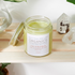 Jar of skincare product on a wooden shelf with plants and crystals