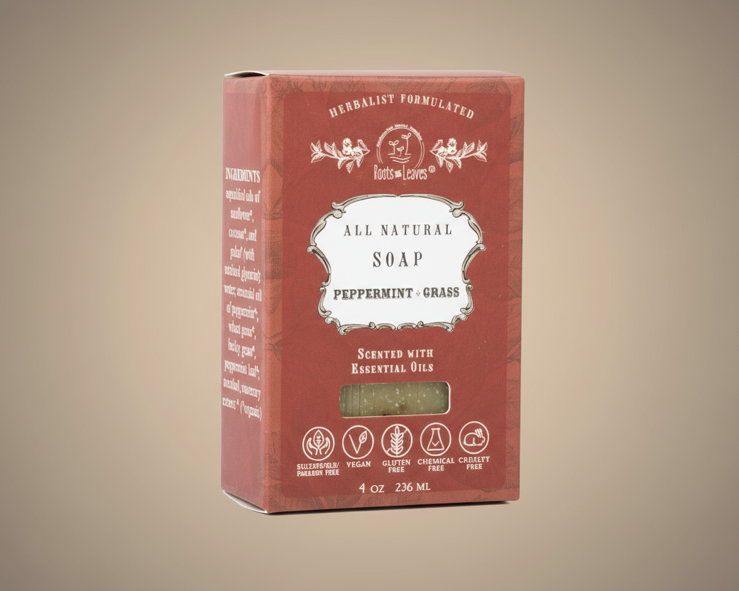 Red box of all natural peppermint grass soap on a beige background