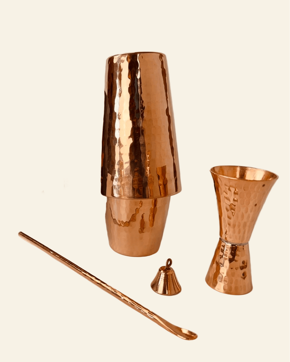 Copper cocktail shaker set with jigger and bar spoon on a white background, featuring Sertodo Cocktail Co branding.
