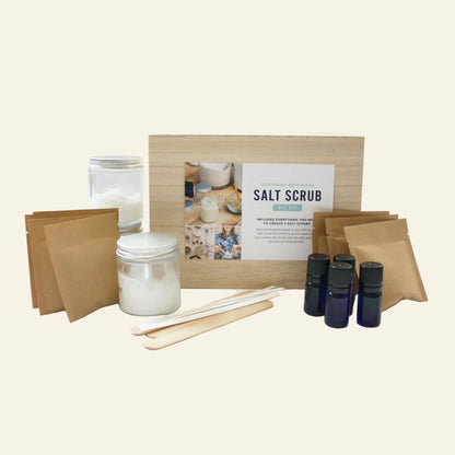 Salt scrub kit with jars, sticks, and bottles on a white background