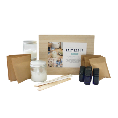 Salt scrub kit with jars, sticks, and bottles on a white background