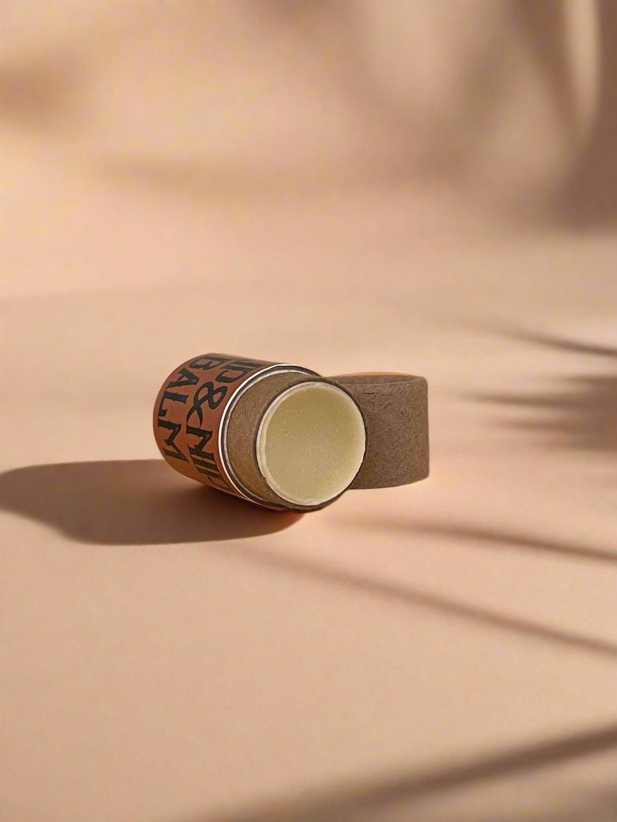 Roll of brown tape on a wooden surface with a light gray background