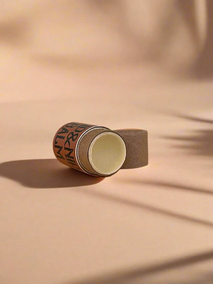 Roll of brown tape on a wooden surface with a light gray background